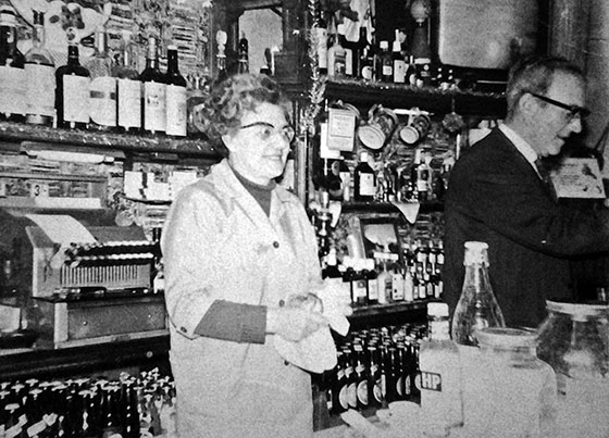 Davey and Nellie behind the bar at Davey's Bar, Leith