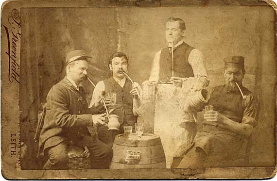 Cabinet print of four men with clay pipes and drinks  -  by J Greenfield