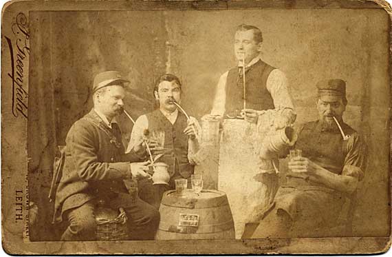 Cabinet print of four men with clay pipes and drinks - by J Greenfield