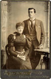 Cabinet Print by John McKean  -  A couple beside a table