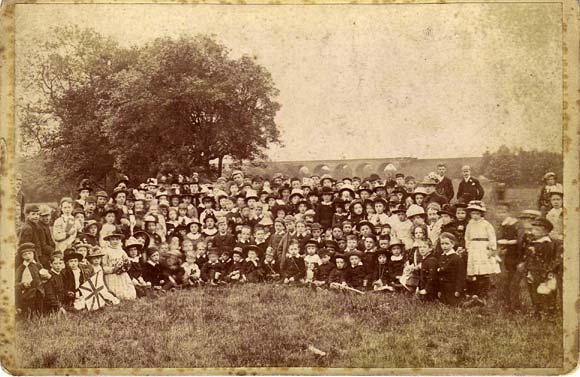 Cabinet print of a group of children with a viaduct in the background