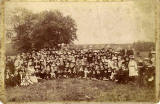 A cabinet print by James Pike of a group of children with a viaduct in the backgraound