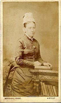 Carte de visite from the Edinburgh studio of Marshall Wane  -  Lady beside a book case