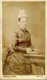 Carte de visite from the Edinburgh studio of Marshall Wane  -  Lady beside a book case