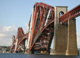 The Forth Rail Bridge, covered in scaffolding and partially encapsulated for painting.