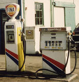Zoom-in to two petrol pumps on the right at a Fina petrol station in the Scottish Highlands