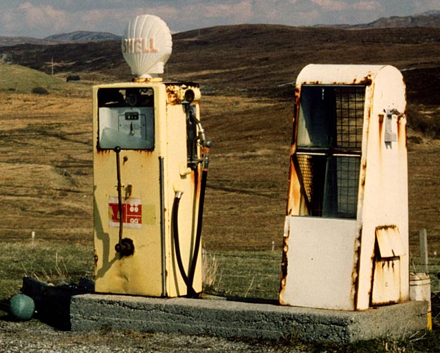 Zoom in to the petrol pump at a faded petrol station in the Scottish highlands