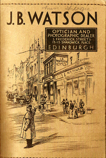 Zoom-in to the front of a J B Watson Developing and Printing wallet, 1934 to 1938