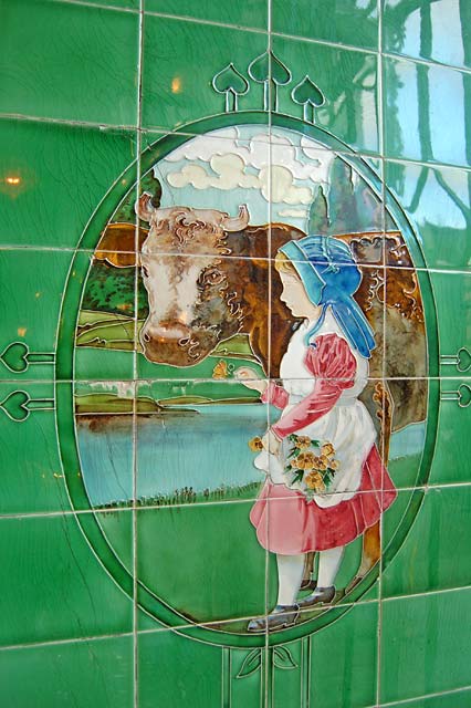 Tiles in a Buttercup Dairy Co shop, based on a painting by Tom Curr