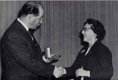 EPS President, George Paterson, makes a presentation of a gold watch to to Grace Alison - 1964
