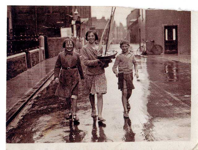 Photographs by K F Balmain  -  Three children in North Berwick and a model yacht