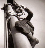 Photographer Andrew Bingham climbing a mast at Leith Docks