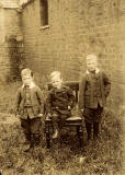Outdoor photograph of three boys by  Milne & Co