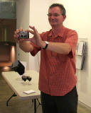 Edinburgh  -  16 August 2005  -  Martin Parr takes a photograph of a customer at Stills Gallery