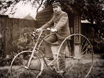 Ebenezer Turner in his back garden, sitting on his tricycle