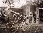 Ebenezer Turner in his back garden, standing beside his tricycle