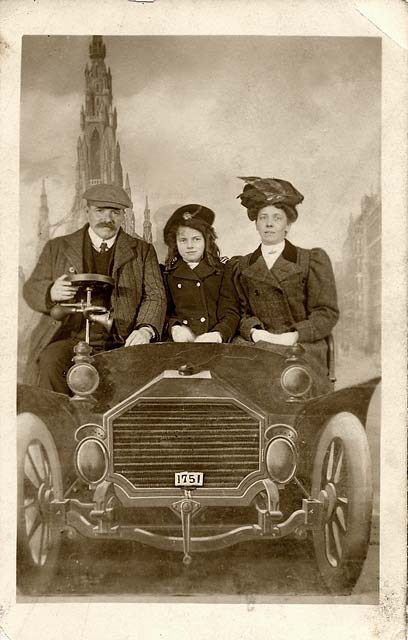 Postcard portrait with a studio car and backdrop by Claude Low