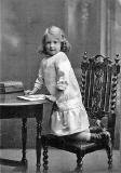 Postcard Portrait from the studio of Alec Roberts, Piershill, Edinburgh  -  Allan Dodds' mother, photographed on a seat in the studio, around 1914