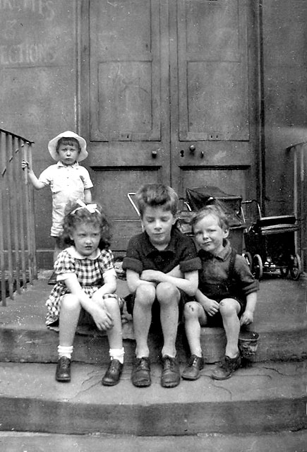 Four young children on the steps at Albany Street  -  around 1945-46