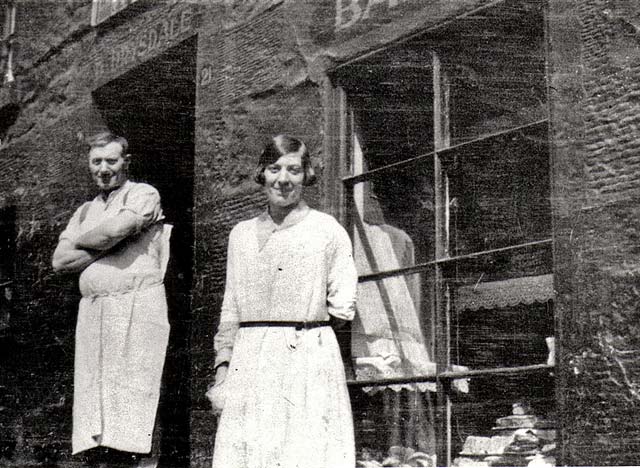 David Drysdale and his daughter outside his baker's shop at 21 Arthur Street, around 1937