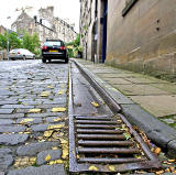 Metal Gutter and Drain at the edge of Calton Hill, the steep street leading up from Leith Street to Regent Road