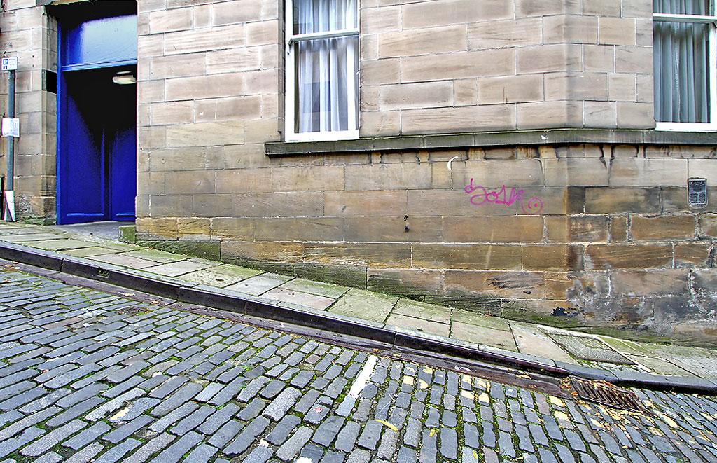 Metal Gutter and Drain at the edge of Calton Hill, the steep street leading up from Leith Street to Regent Road