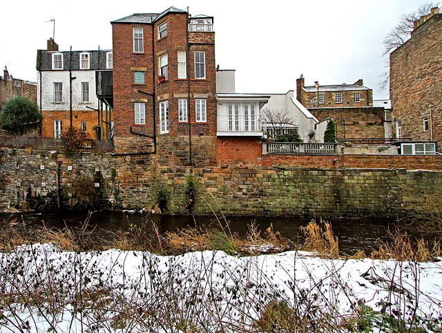 Looking east across the Water of Leith to the backs of the buildings in Dean Bank Lane, Stockbridge  -  December 2009