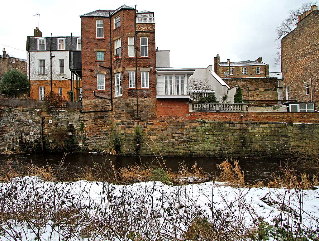 Looking east across the Water of Leith to the backs of the buildings in Dean Bank Lane, Stockbridge  -  December 2009