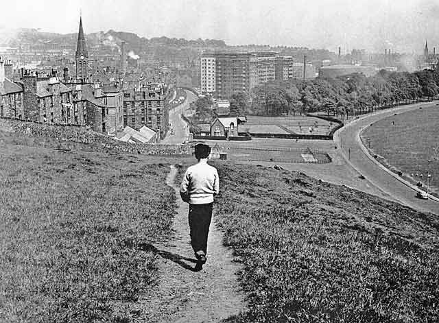 Looking down on Dumbiedykes from a path through Holyrood Park leading from James Clark's School