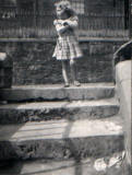 Linda Graham, aged 4, standing on the steps to the houses in Dumbiedykes Road, near the 'Big Green'