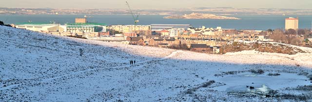 Looking north from Hunter's Bog in Holyrood Park to Hibs Stadium and the island of Inchkeith