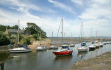 Cramond  -  The former Ferryman's House and boats moored in the River Almond at low tide