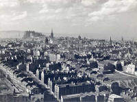 Looking down on Dumbiedykes and out towards Edinburgh Castle from Salisbury Crags  -  probably around the 1950s.