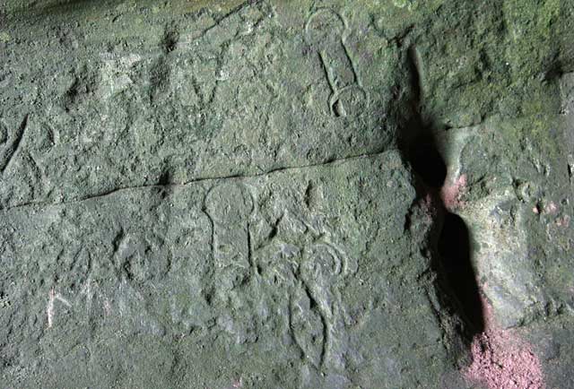 Rock art carvings at Jonathan's Cave, East Wemyss, Fife  -  dumbbells and  a fish