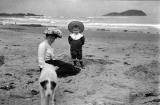 Nurse Annie and Tommy with dog, and Craigleith Island in the background  -  Around 1905