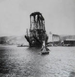 A Yacht sails past the Forth bridge, under construction