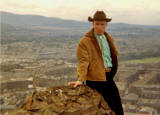 Bob Penry of 'The Gatekeepers' folk group, 1965-66, photographed on Arthur's Seat, Holyrood Park  -  St Leonards district is in the background