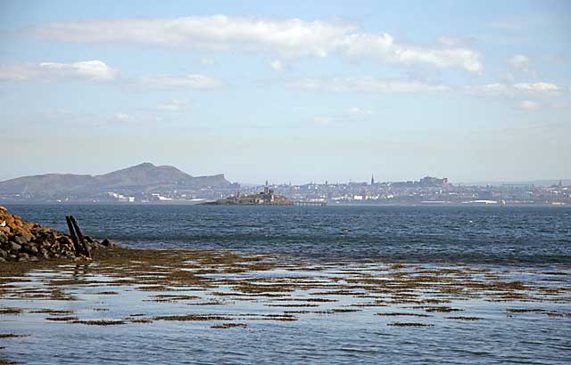 Inchmickery and the skyline of Edinburgh, seen from beside the Island of Inchcolm in the Firth of Forth