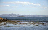 Inchmickery and the skyline of Edinburgh, seen from beside the Island of Inchcolm in the Firth of Forth