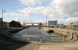 View, looking along Alexandra Dock beside the old swing bridge in Leith Harbour, towards Ocean Terminal shopping centre and cinema complex.