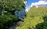 Police Box almost hidden in the bushes beside Glasgow Road, west of Maybury Junction