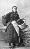 A postcard by DF & Co  -  Newhaven Fishwife in working dress, with a creel.