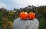 Haloween  -  Two pumpkins placed on the large stone at the SE corner of The Mound Precinct - Balmoral Hotel, Edinburgh Old Town and former Bank of Scotland Head Office are in the background