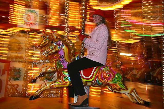 Polina Smirnoff from Moscow on the Galloping Horses Christmas Carousel beside the Scott Monument in East Princes Street Gardens