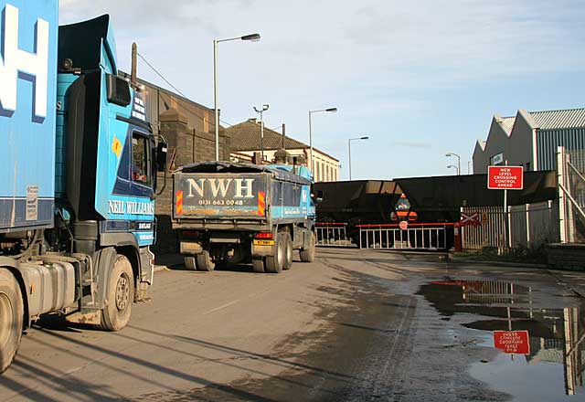 A train of empty coal wagons crosses a new level crossing at Seafield and enters Leith Docks