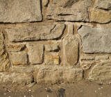 A stone bottle and glass in a wall at Captain's Road, Liberton, Edinburgh