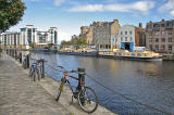 Cycles on the North Bank of the Water of Leith;  barges on the south bank, at The Shore, Leith