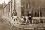 Photo of a barrow box and 4 children, taken around 1933.  Where might this photo have been taken?