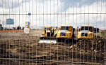 Edinburgh Waterfront  -  Work begins to prepare the land in Granton Western Harbour for developments in the background.  In the foreground is an empty  Irn Bru bottle  -  22 June 2004