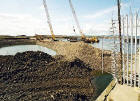 Reclaiming the land in Granton Western Harbour  -  looking to the north-west from Middle Pier towards pile driving in the harbour  -  July 2004